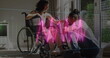 Image of neon heart rate over happy biracial couple, woman on wheelchair