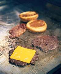 Canvas Print - Cooking burgers on hot grill