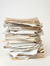 messy stack of white papers on a plain white background