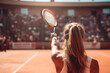 A female professional tennis player seen from behind greeting the crowd after winning a major clay court tennis tournament