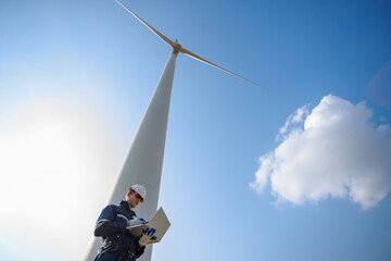 man engineer wearing safety uniform using laptop plan about renewable energy at station energy power