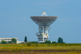 Fototapeta Las - closeup huge radio telescope among fields