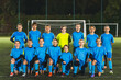 © PoppyPix - school girls football team group photo in a stadium at night before the match, full shot. High quality photo