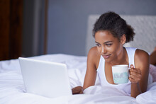 Black woman, computer or tea in bed to relax, scroll or search on internet, social media or network. Female influencer, coffee or laptop as checking, message or email for viral meme and blog post