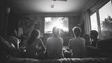 Fototapeta Desenie - A group of teenagers gathered together to watch a movie in their room, Friends gathered around a big screen TV, Friends Watching Film Together, People watching tv