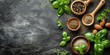 Various herbs and spices on black background. Top view with copy space