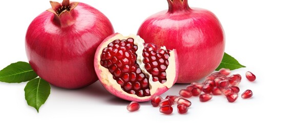 Wall Mural - Three pomegranates, a superfood known for its juicy seeds, displayed with leaves on a white background. A staple food and popular ingredient in many cuisines