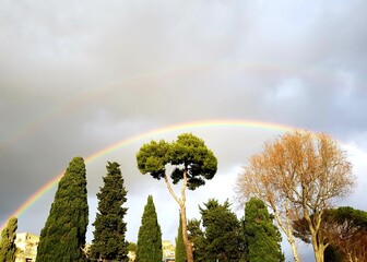 Wall Mural - Rainbow in the sky over the city of Rome, Italy.