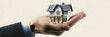 © john - one hand wearing suit holding house. white background