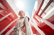 High fashion woman wearing white suit in futuristic metropolis. Generative AI