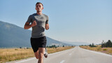 Fototapeta  - A dedicated marathon runner pushes himself to the limit in training.