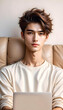 © anmitsu - Beautiful and handsome young male freelancer sits on a comfortable sofa and browses the internet on a laptop to successfully conduct business. She has luxury interior, work from home concept