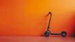 A colorful scooter leans against a striking orange wall, creating a visually appealing contrast