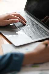 Close up of hands of diverse people on office desk work together on laptop discussing ideas, multiethnic businesspeople negotiate brainstorm using computer cooperating at meeting. Partnership concept