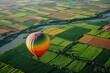 A hot air balloon gracefully floats over a lush green field, creating a breathtaking sight, A hot air balloon ride over a patchwork of colorful fields and rivers, AI Generated