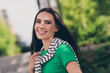 © deagreez - Photo of cute good mood lady wear green t-shirt enjoying warm air blowing sunshine walking outside urban city street