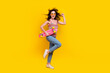 © deagreez - Full body photo of active girl fluttering hair wear knit tank hold skateboard run to empty space isolated on yellow color background