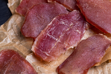 Wall Mural - pieces of dried pork with spices and salt on crumpled paper