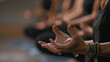 The instructors hands move gracefully as they lead the class through each pose