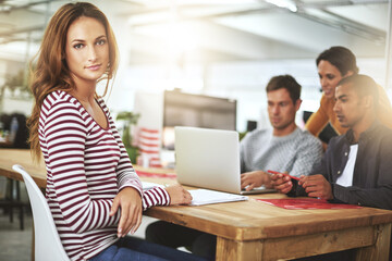 Poster - Portrait, serious and business woman at office in meeting in startup company for creative career or job at table. Face, coworking and professional entrepreneur at desk, employee or designer with team