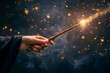 Hand holding magical wooden wand with magic coming out of it