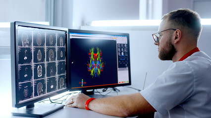 Medical hospital: neurologist use computer, analyze patient's MRI, diagnose brain. Health Clinic Lab: A professional doctor examines a functioning CT scan