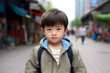 Boy Asian Chinese in his teens or young talking head shoulders shot bokeh out of focus background on a cosmopolitan western street vox pop website review or questionnaire candid photo
