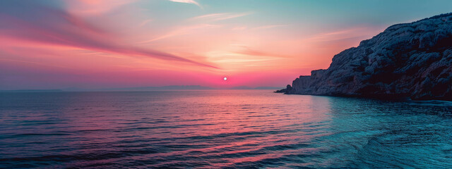 Wall Mural - A beautiful sunset over the ocean with a rocky shoreline