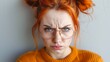 Redhead woman with a skeptical expression and glasses