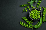 Fototapeta Desenie - Shelled green peas in a bowl. Healthy food. Top view.