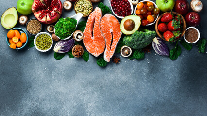 Wall Mural - Top view. Healthy food selection on gray background. Detox and clean diet concept. Foods high in vitamins, minerals and antioxidants. Anti-aging foods.