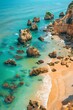 Aerial snapshot capturing the stunning contrast of Algarve's rocky shores against the serene turquoise waters of Portugal.