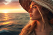Close-up of a pensive young woman in a stylish hat, gazing at a beautiful ocean sunset at sea with copy space. Concept summer vacation, fashion trends, serenity and mindfulness.