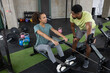 © ReeldealHD images - Personal trainer with a client showing how to use the rowing machine