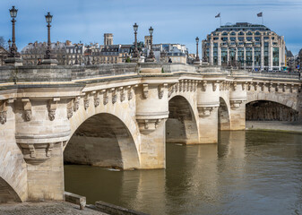 Wall Mural - Paris, France - 03 08 2024: The quays of the Seine. View of Pont Neuf, the Samaritaine building and the Saint-Jacques Tower in the background.