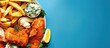 Fish and Chips top view. Fish and chips with tartar sauce on a blue background. web banner with Copy space for text.