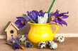 Happy Easter holidays concept; bouquet of snowdrops flowers and quail eggs on a wooden background