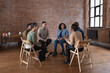 © ReeldealHD images - Group of diverse adults sitting in a circle discussing ideas together