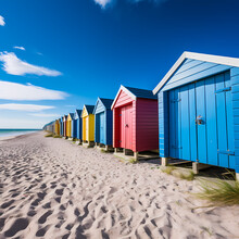 A Row Of Colorful Beach Huts Against A Blue Sky.