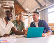© Monkey Business - Three Businessmen Meeting In Modern Office Sitting Around Table Working On Laptop Together
