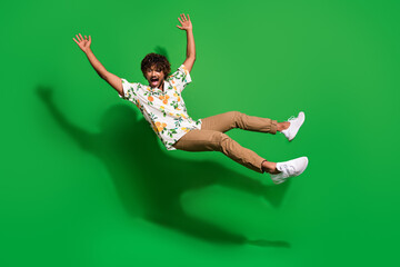 Sticker - Full size photo of pretty young male falling look down dressed stylish citrus print outfit isolated on green color background