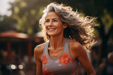 Senior middle aged woman enjoying jogging outdoors in the morning, eldery people healthy lifestyle.