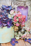 Fototapeta Kwiaty - Vintage bouquet of hydrangeas with candle on wooden background
