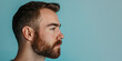 Profile View of a Young Bearded Man with a Short Haircut and Intense Gaze. Banner with copy space