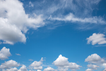 Wall Mural - blue sky background framed with cumulus and cirrus clouds.