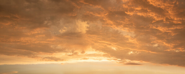 Wall Mural - golden sunset scenery with yellow illuminated clouds