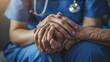 © MP Studio - close-up of a healthcare worker in blue scrubs holding and comforting the hands of an elderly patient