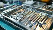 A tray of surgical instruments is displayed on a table. The instruments include a variety of scissors, tweezers, and other tools used in medical procedures. Concept of professionalism and precision