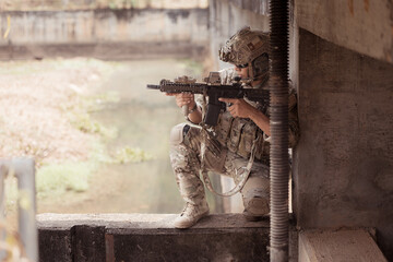 Wall Mural - Soldiers in camouflage military uniforms carrying weapons, Reconnaissance missions in the tropical forest area, Assault infantry battle training.