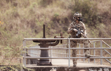 Wall Mural - Soldiers in camouflage military uniforms carrying weapons, Reconnaissance missions in the tropical forest area, Assault infantry battle training.